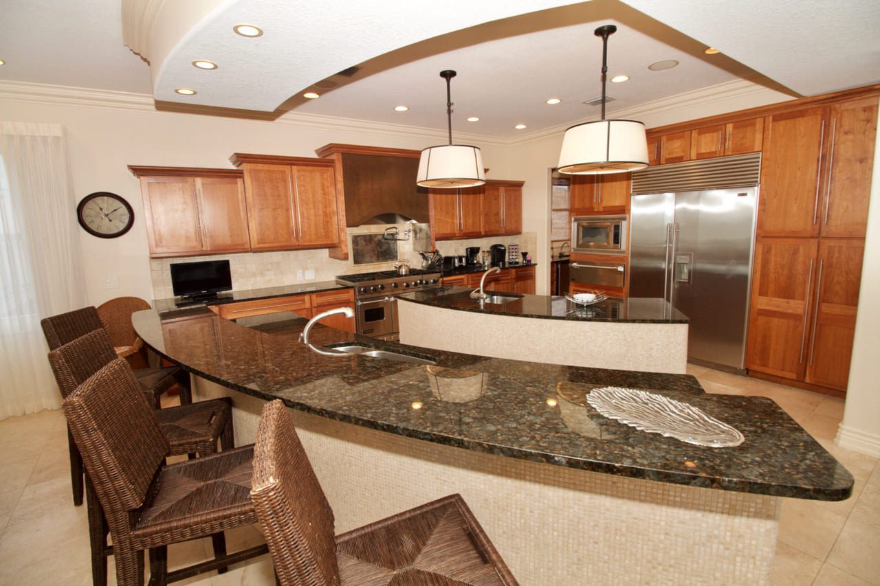 A kitchen with a large island and stainless steel appliances.